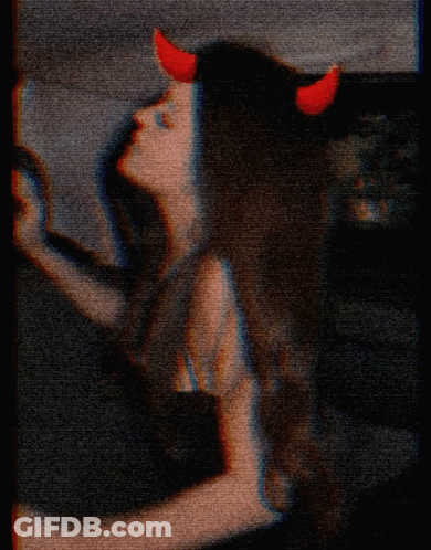 Woman With Red Horns And Cross On Face GIF