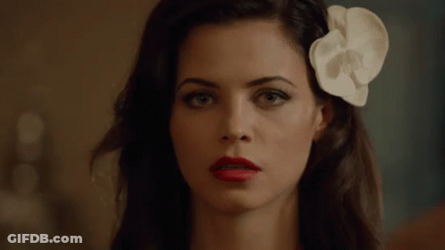Woman With Red Lipstick And White Flower In Hair GIF
