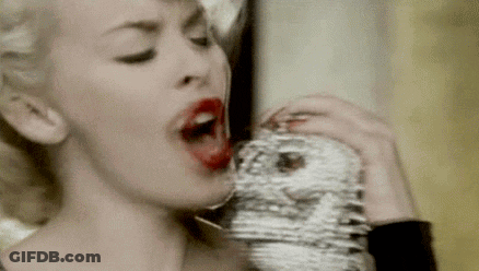 Woman With Red Lipstick Drinking From Face Glass GIF