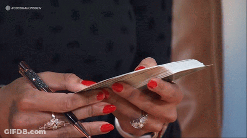 Woman With Red Nails Holding Pen And Paper GIF