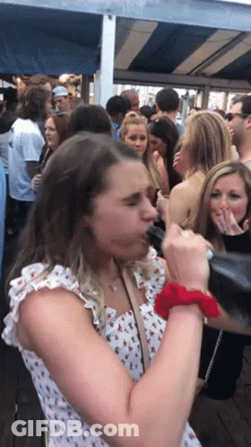 Woman With Red Scrunchie In Crowd GIF