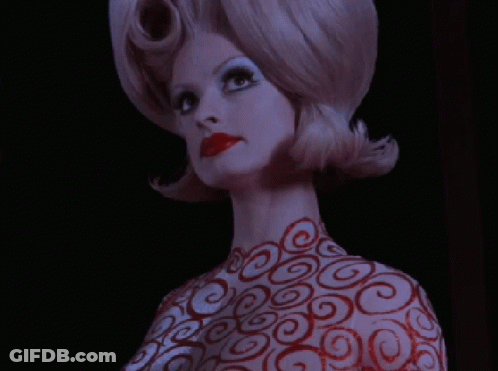 Woman With Red Swirls On Body And Hair GIF