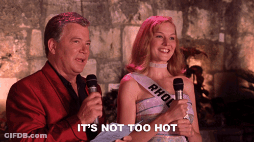 Woman With Rhol Sash Next To Man Holding Microphones GIF