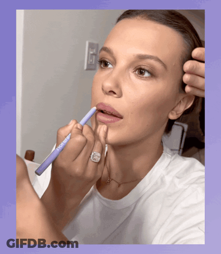 Woman With Ring Applying Lipstick GIF