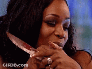 Woman With Ring Holding Knife In Mouth GIF