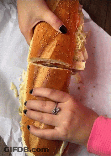 Woman With Ring Holding Sandwich GIF