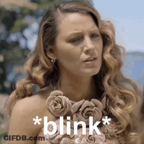 Woman With Rose Necklace Saying Blink GIF