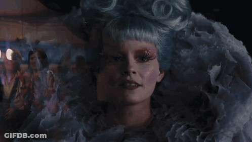 Woman With Scarf Standing In Crowd GIF