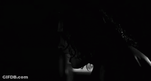 Woman With Scary Face In Darkness GIF