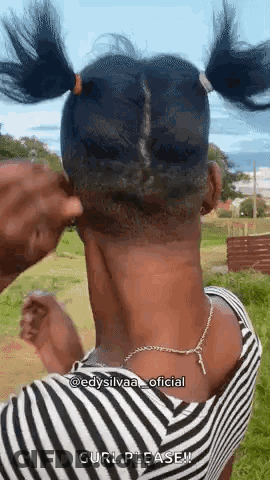 Woman With Shaved Head And Pigtails In Field GIF