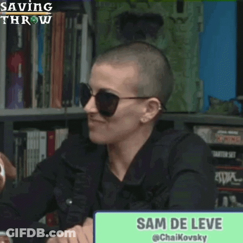 Woman With Shaved Head And Sunglasses Laughing In Front Of Sam De Leve Sign GIF