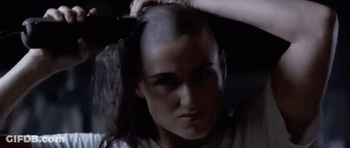 Woman With Shaved Head Holding Bottle GIF