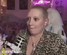 Woman With Shaved Head Wearing Headphones And Leopard Print Shirt GIF