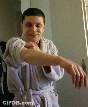 Woman With Shaved Head Wearing Purple Robe GIF