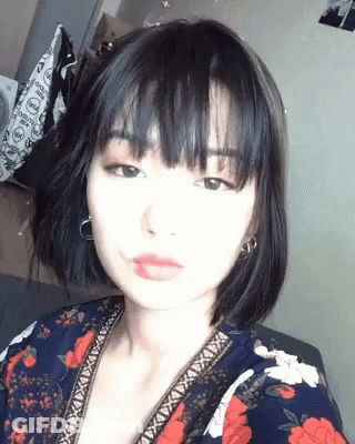 Woman With Short Black Hair Taking Selfie GIF