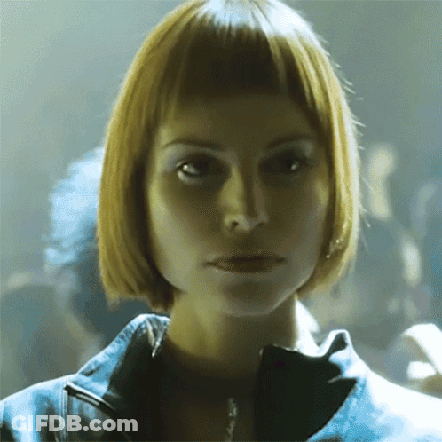 Woman With Short Blonde Hair Looking At Camera GIF