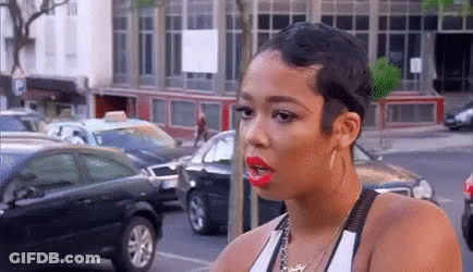 Woman With Short Hair And Red Lipstick In Parking Lot GIF