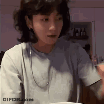 Woman With Short Hair At Table With Food GIF