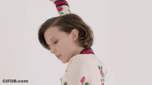 Woman With Short Hair In White Sweater With Roses GIF