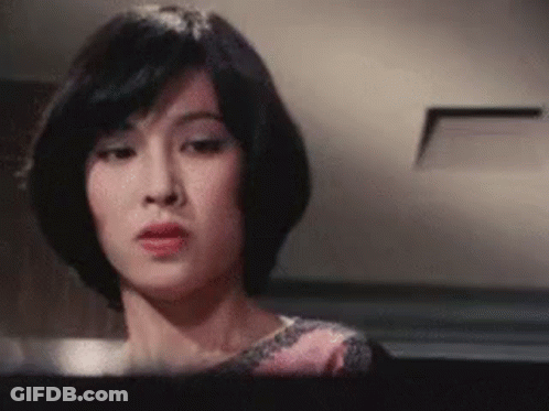 Woman With Short Hair Looking At Camera GIF
