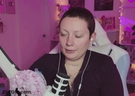 Woman With Short Hair Sitting In Chair With Headphones GIF