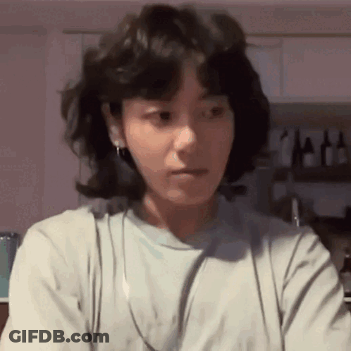 Woman With Short Hair Wearing Headphones Making Face GIF