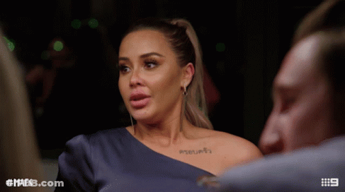 Woman With Shoulder Tattoo Talking To Man GIF