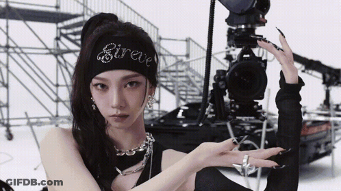 Woman With Sireve Headband Facing Camera GIF