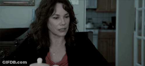Woman With Small White Container At Table GIF