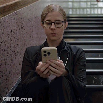 Woman With Stethoscope Looking At Phone GIF