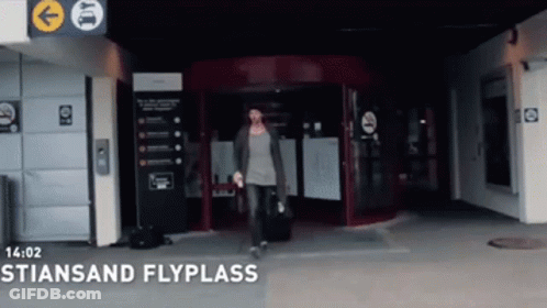 Woman With Suitcase Enters Stiensan Flyplass GIF