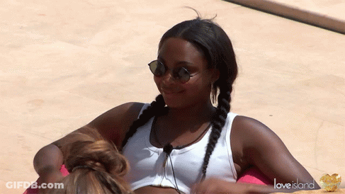 Woman With Sunglasses And White Tank Top On Love Island Float GIF