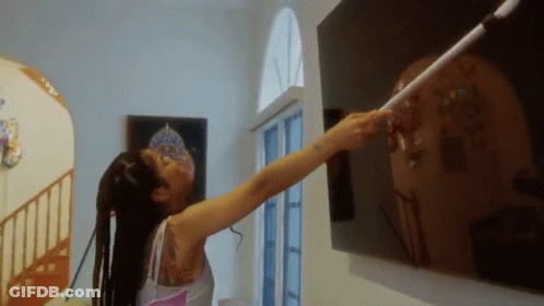 Woman With Tattoo Pointing At Wall GIF