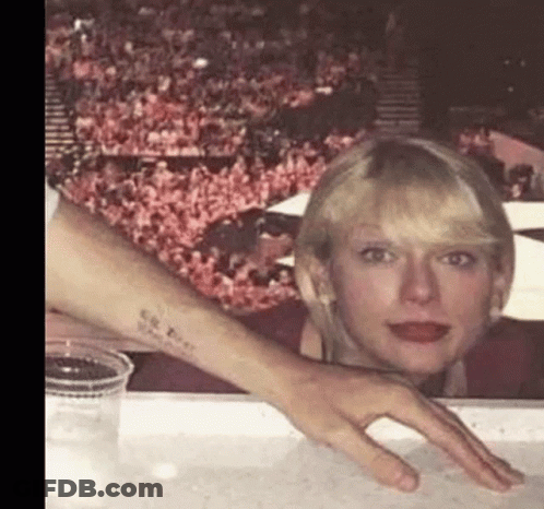 Woman With Tattoo Sitting Next To Man's Hand GIF