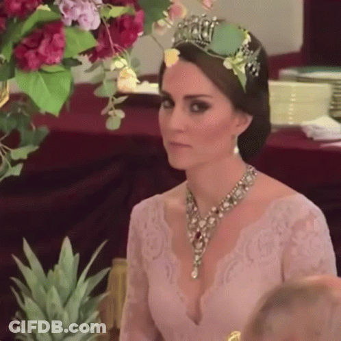 Woman With Tiara And Necklace At Table GIF