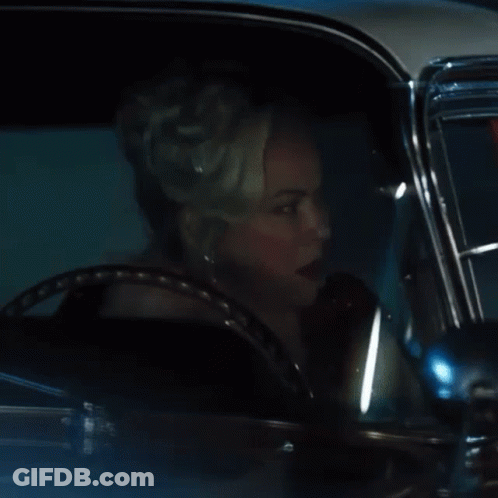 Woman With Tiara Driving Car At Night GIF