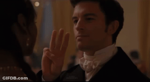 Woman With Tiara Looks At Man In Suit GIF