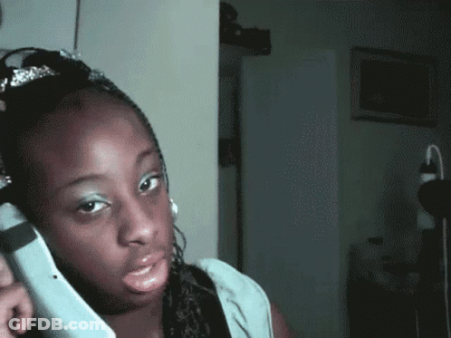 Woman With Tiara Talking On Phone GIF