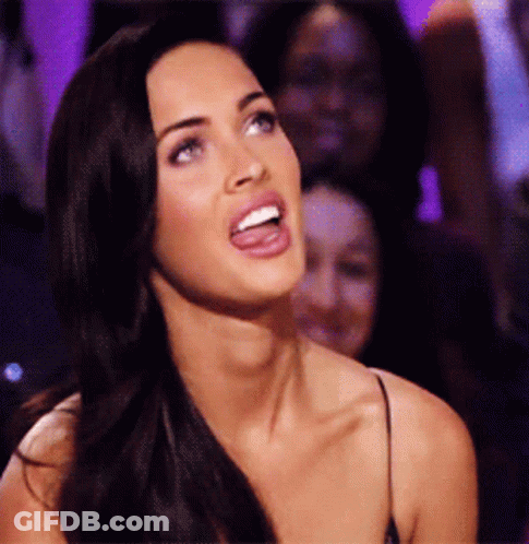 Woman With Tongue Out In Dark Room GIF