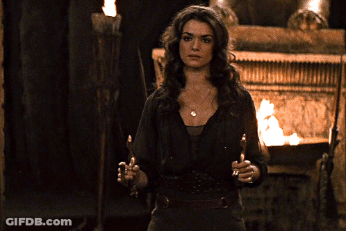 Woman With Torch In Front Of Fire GIF