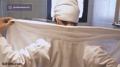 Woman With Towel On Head In Bathroom GIF