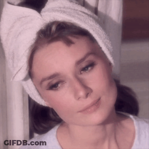 Woman With Towel Wrapped Around Head Looks At Camera GIF