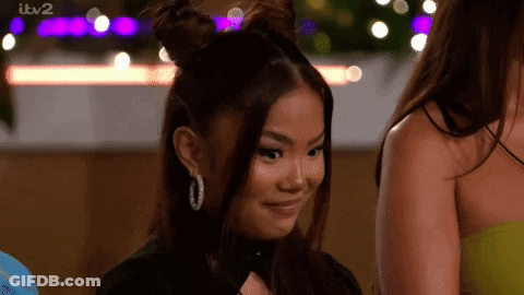 Woman With Two Buns Smiling Next To Another GIF