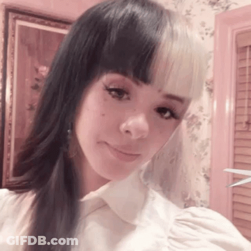 Woman With Two Different Colored Hair Taking Selfie GIF