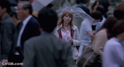Woman With Umbrella Walking Through Crowd GIF