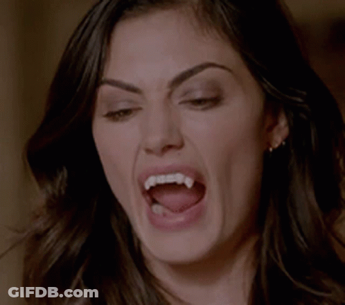 Woman With Vampire Teeth Making Funny Face GIF