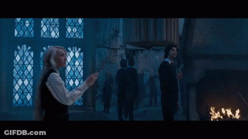 Woman With Wand By Window Man With Wand Behind GIF