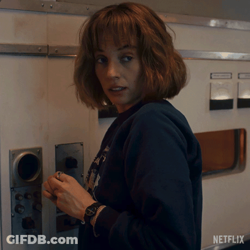 Woman With Watch Next To Netflix Logo GIF