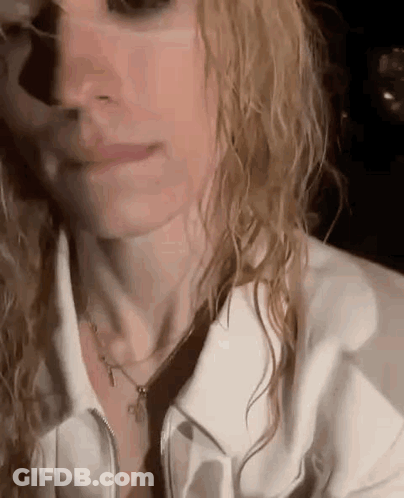 Woman With Wet Hair White Jacket And Necklace GIF
