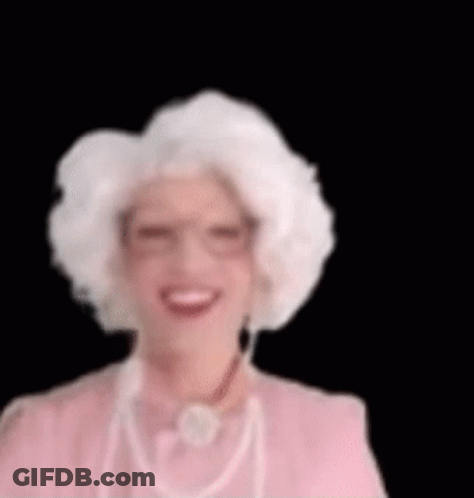Woman With White Hair And Glasses Smiling In Pink Dress GIF